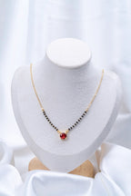 Ruby Red Solitaire Mangalsutra flat lay on peach background - Nyara