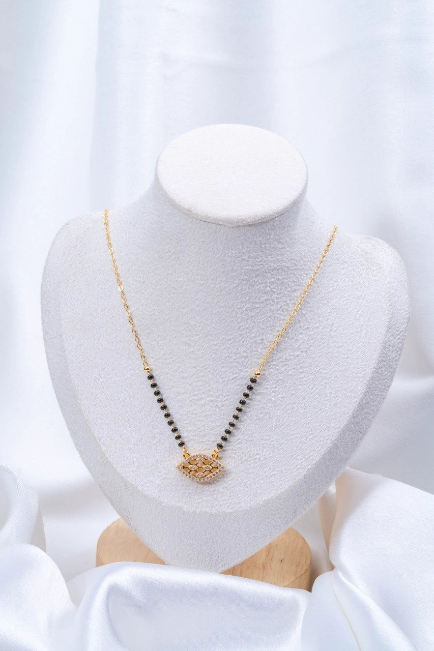 Evil Eye Diamond Mangalsutra flat lay on peach background - Nyara