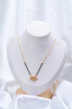 Evil Eye Diamond Mangalsutra flat lay on peach background - Nyara