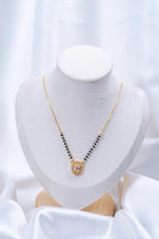 Oval Solitaire Diamond Mangalsutra flat lay on peach background - Nyara