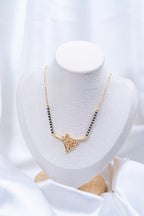 Diamond Lattice Net Mangalsutra flat lay on peach background - Nyara