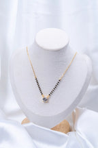 Round Solitaire CZ Mangalsutra flat lay on peach background - Nyara