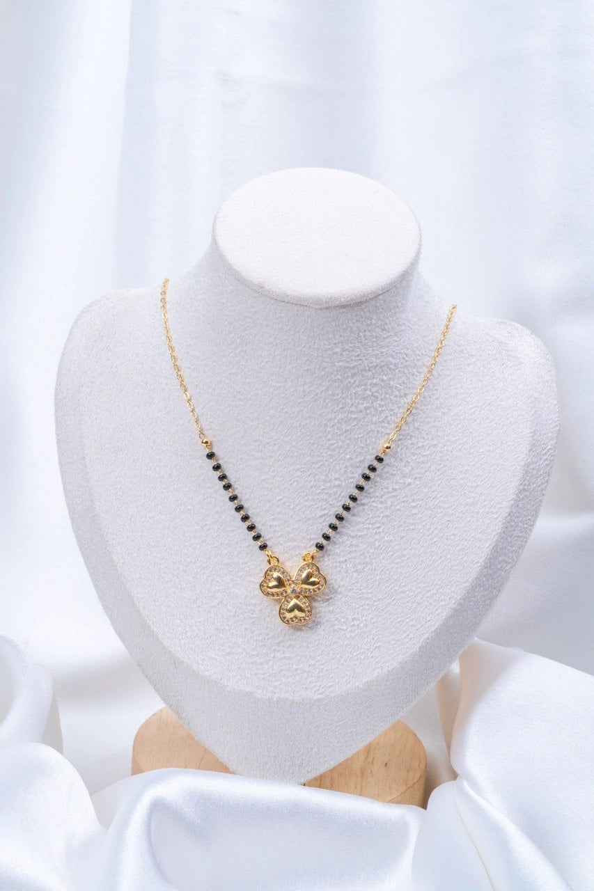 Four Heart Clover Diamond Mangalsutra flat lay on peach background - Nyara