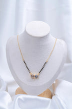 Double CZ Solitaire Mangalsutra flat lay on peach background - Nyara
