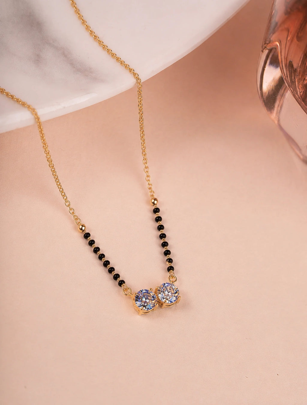 Double CZ Solitaire Mangalsutra on jewellery stand - Nyara
