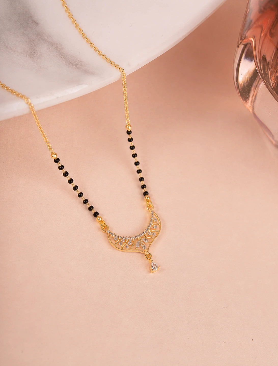 Traditional Filigree Crescent Mangalsutra on jewellery stand - Nyara