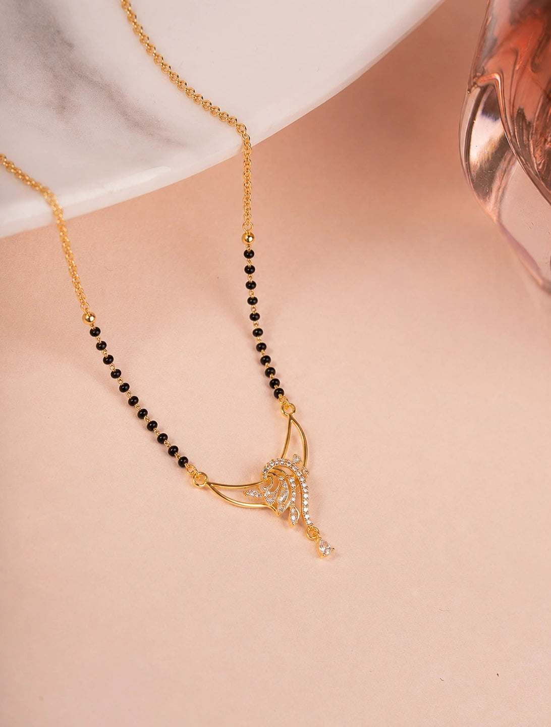 Wing Diamond Mangalsutra flat lay on peach background - Nyara