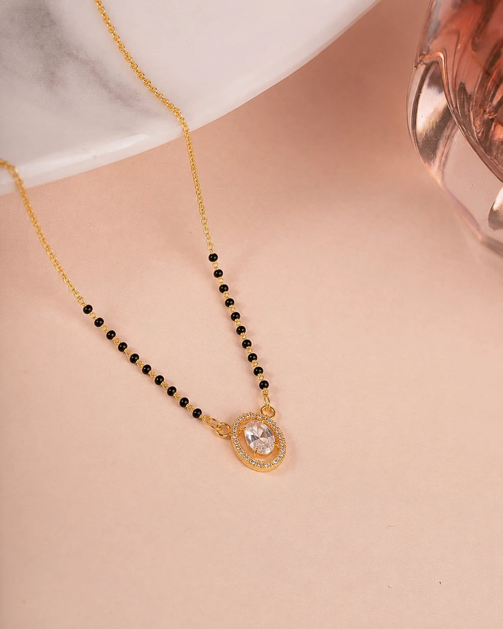 Oval Solitaire Diamond Mangalsutra on jewellery stand - Nyara