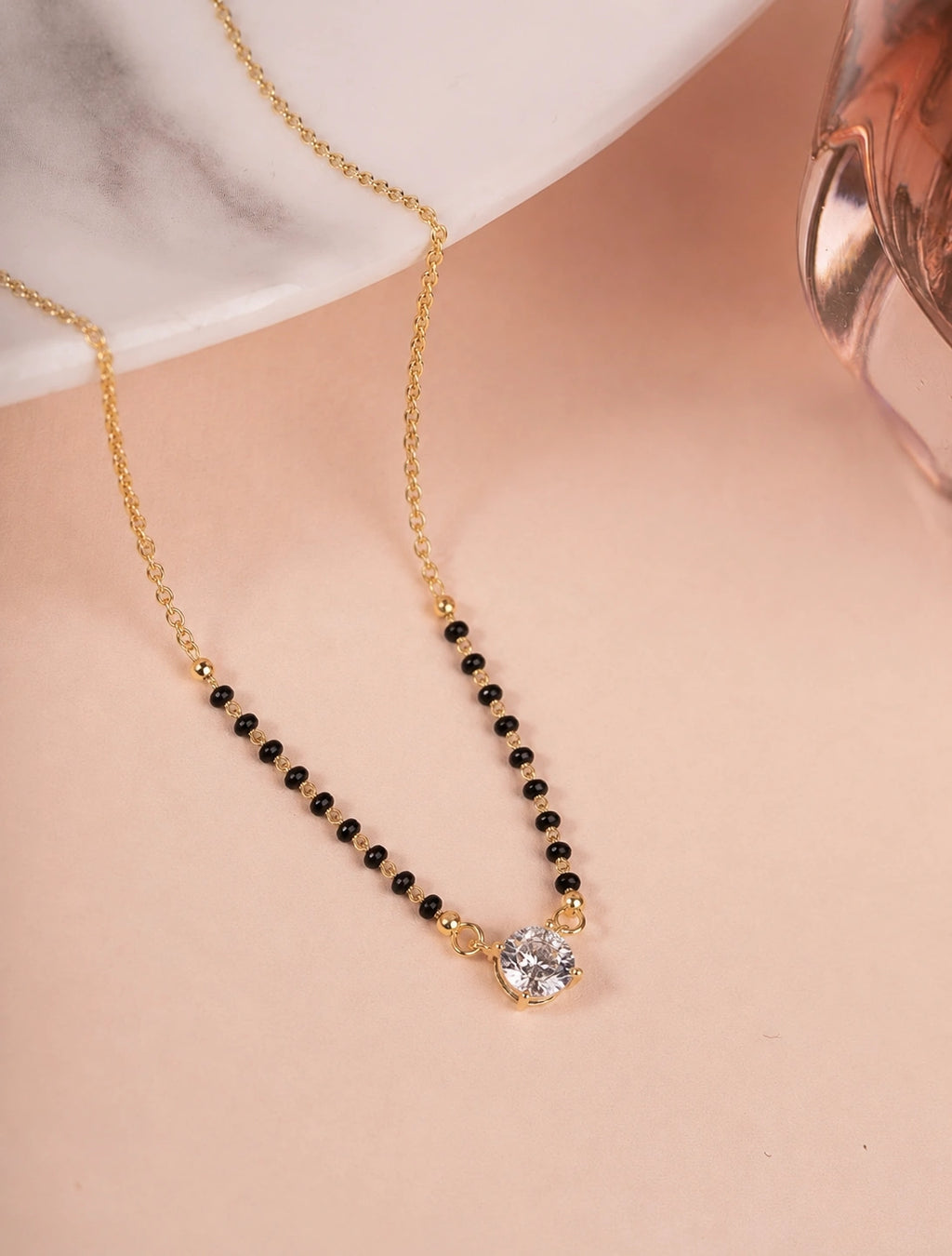Round Solitaire CZ Mangalsutra on jewellery stand - Nyara
