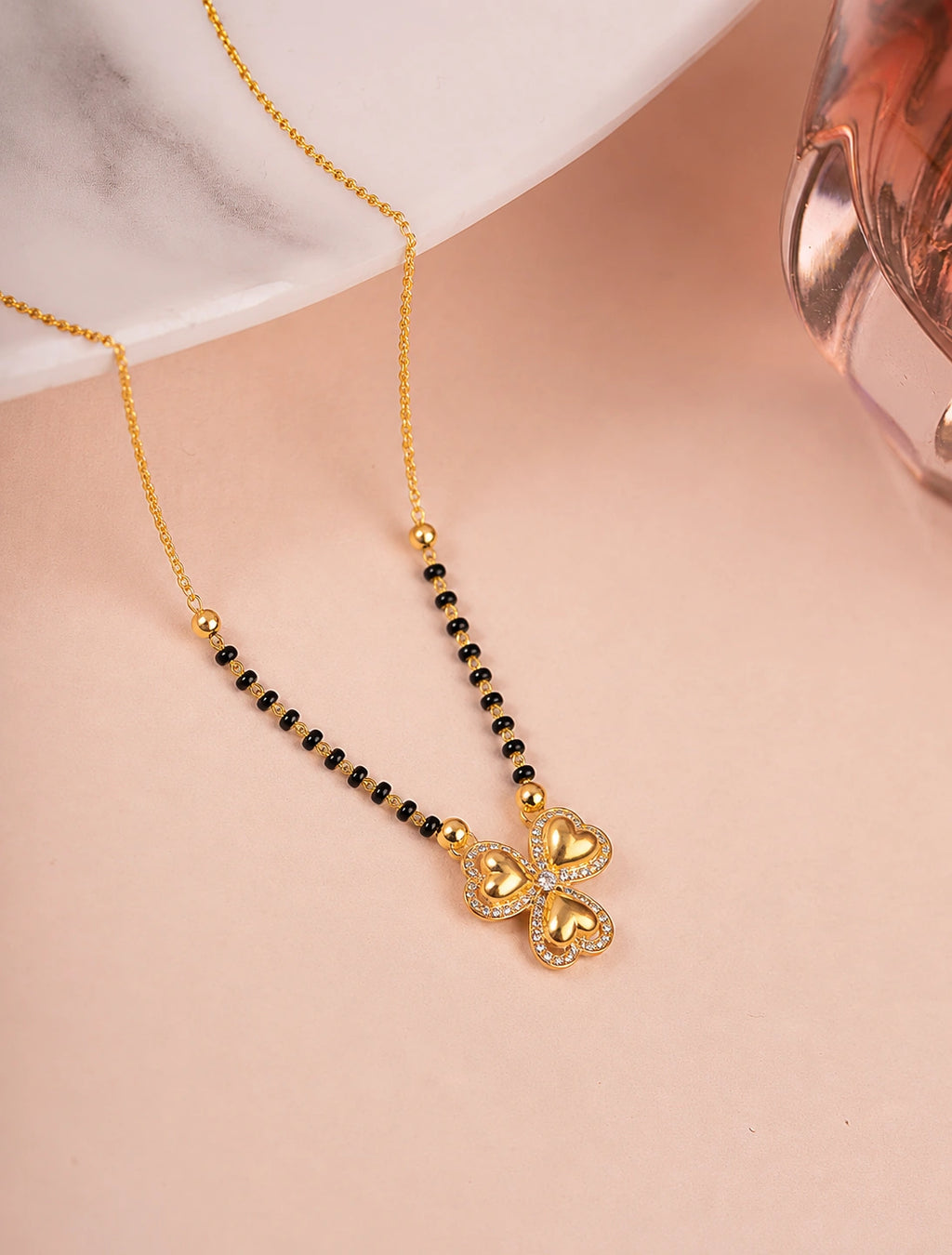 Four Heart Clover Diamond Mangalsutra on jewellery stand - Nyara